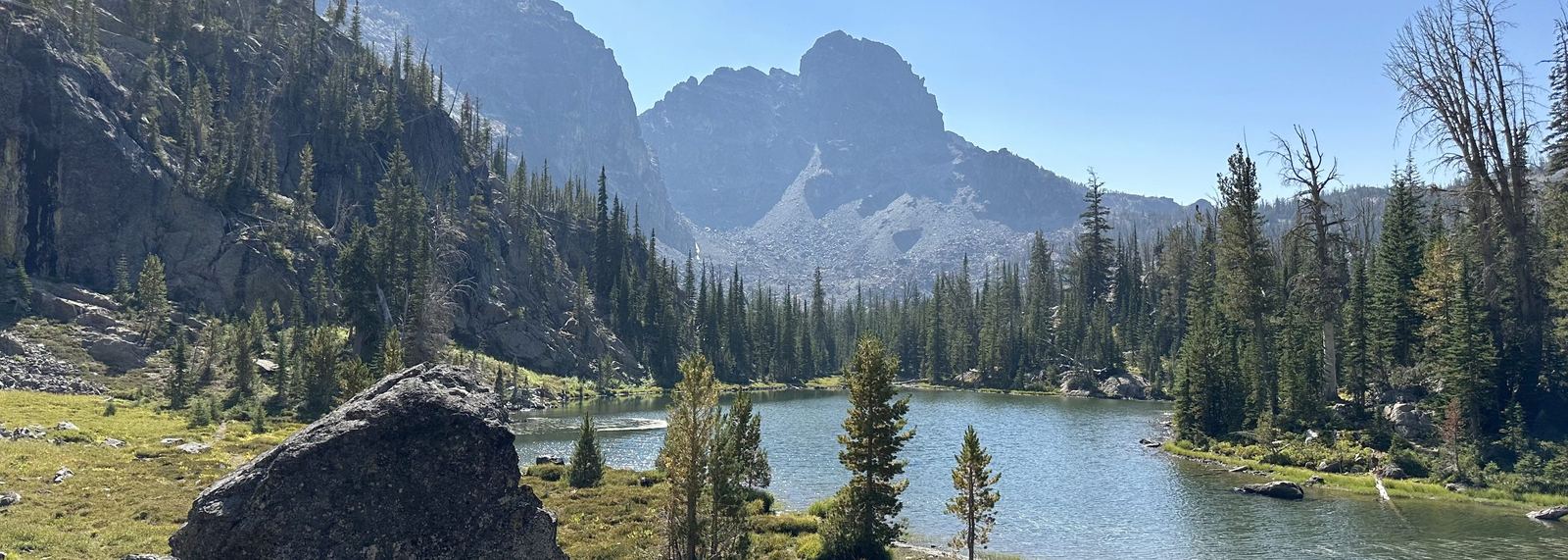 An alpine lake beneath a granite peak in the Idaho high country